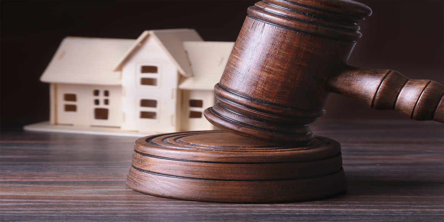 Foreclosure legal concept with gavel and wooden house